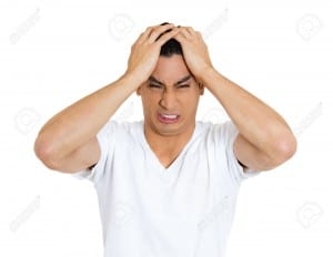 Closeup portrait, stressed, frustrated, crazy man, hands on head, having panic attack, isolated white background. Negative human face expressions, emotions, feelings, attitude, perception