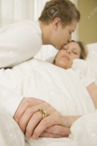 7189766-Loving-husband-caring-for-sick-wife-in-bed-Stock-Photo-kissing