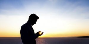 Silhouette of a praying man