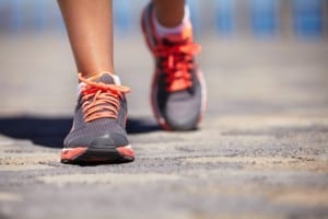 Cropped view of a pair of woman's feet wearing sports trainers and walking